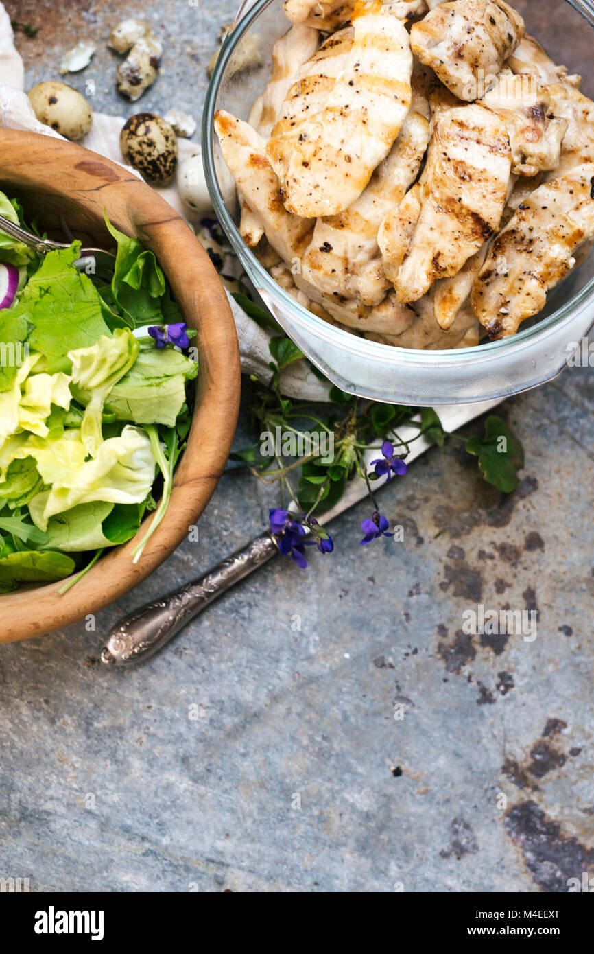 Grilled chicken and Salad with quail egg and edible flowers Stock Photo