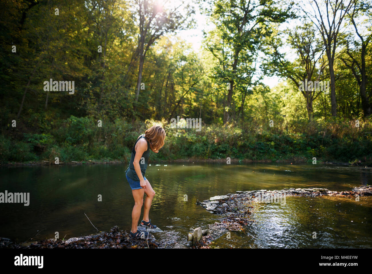 Woman walking along riverbank hi-res stock photography and images - Alamy