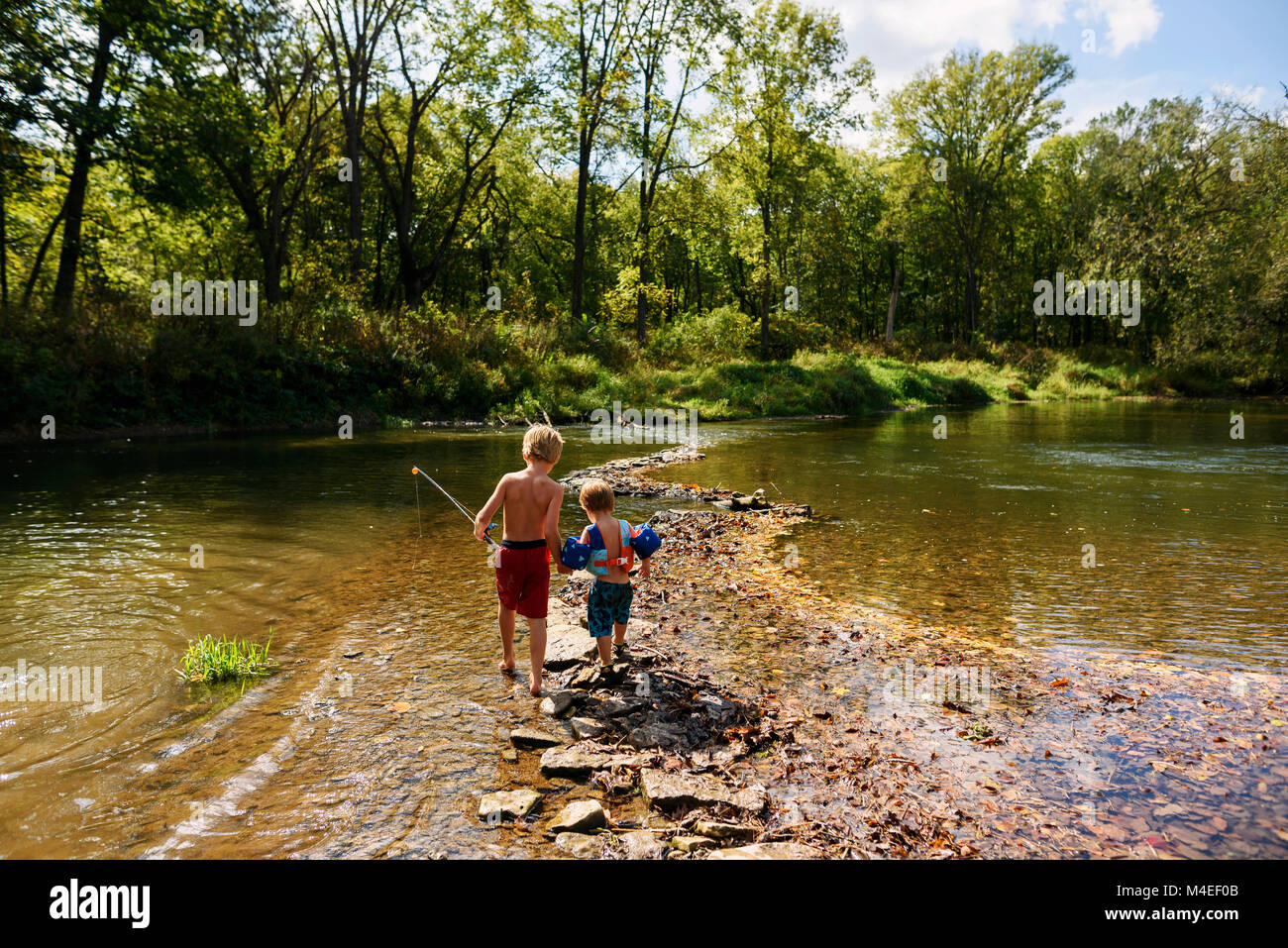 Children crossing a river hi-res stock photography and images - Alamy