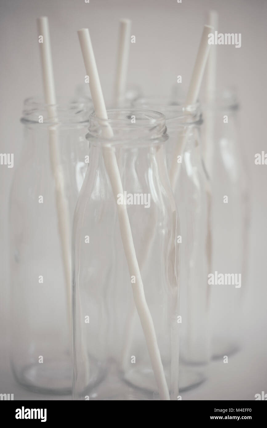 Five glass bottles with drinking straws Stock Photo Alamy