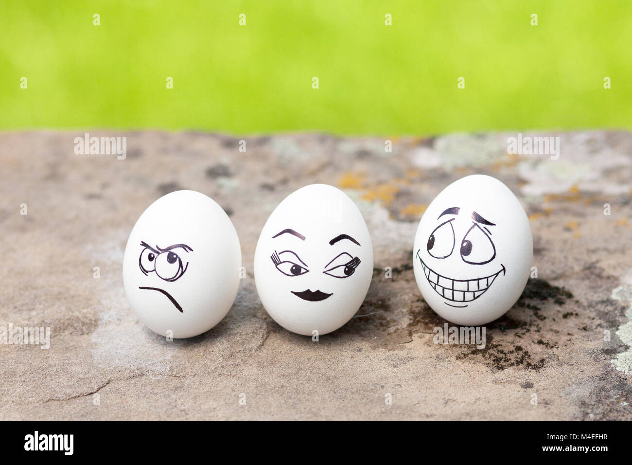 Mischievous, angry and flirty faces drawn on eggs Stock Photo