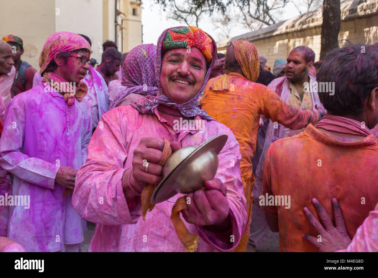 Barsana, India - March 17, 2016: Hindu devotees celebrate Lathmar Holi in Barsana village, Uttar Pradesh, India. Stock Photo
