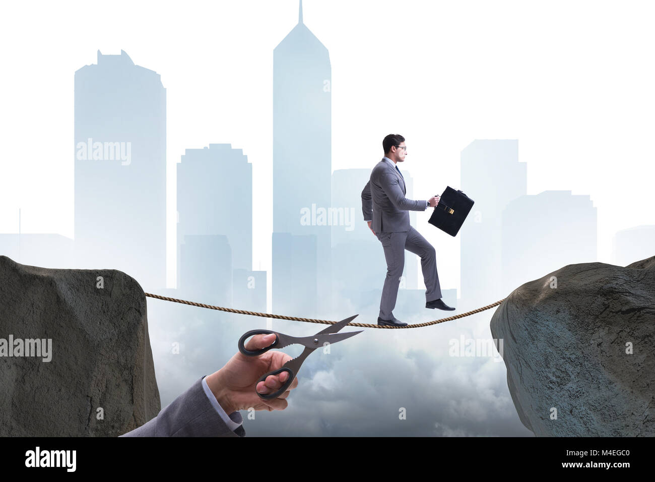 Hand cutting the rope under businessman tightrope walker Stock Photo ...