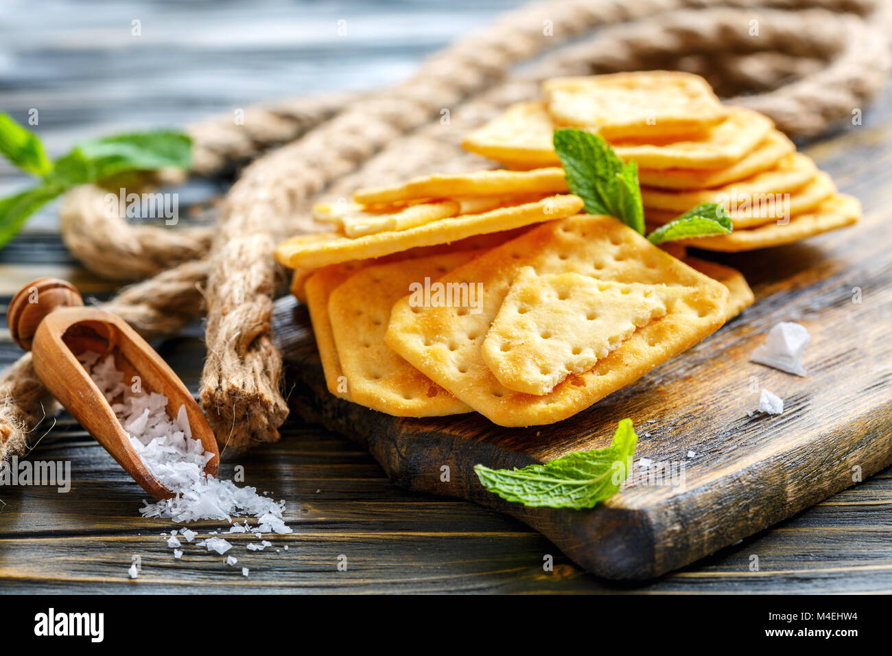 Crisp crackers and a wooden scoop with salt. Stock Photo