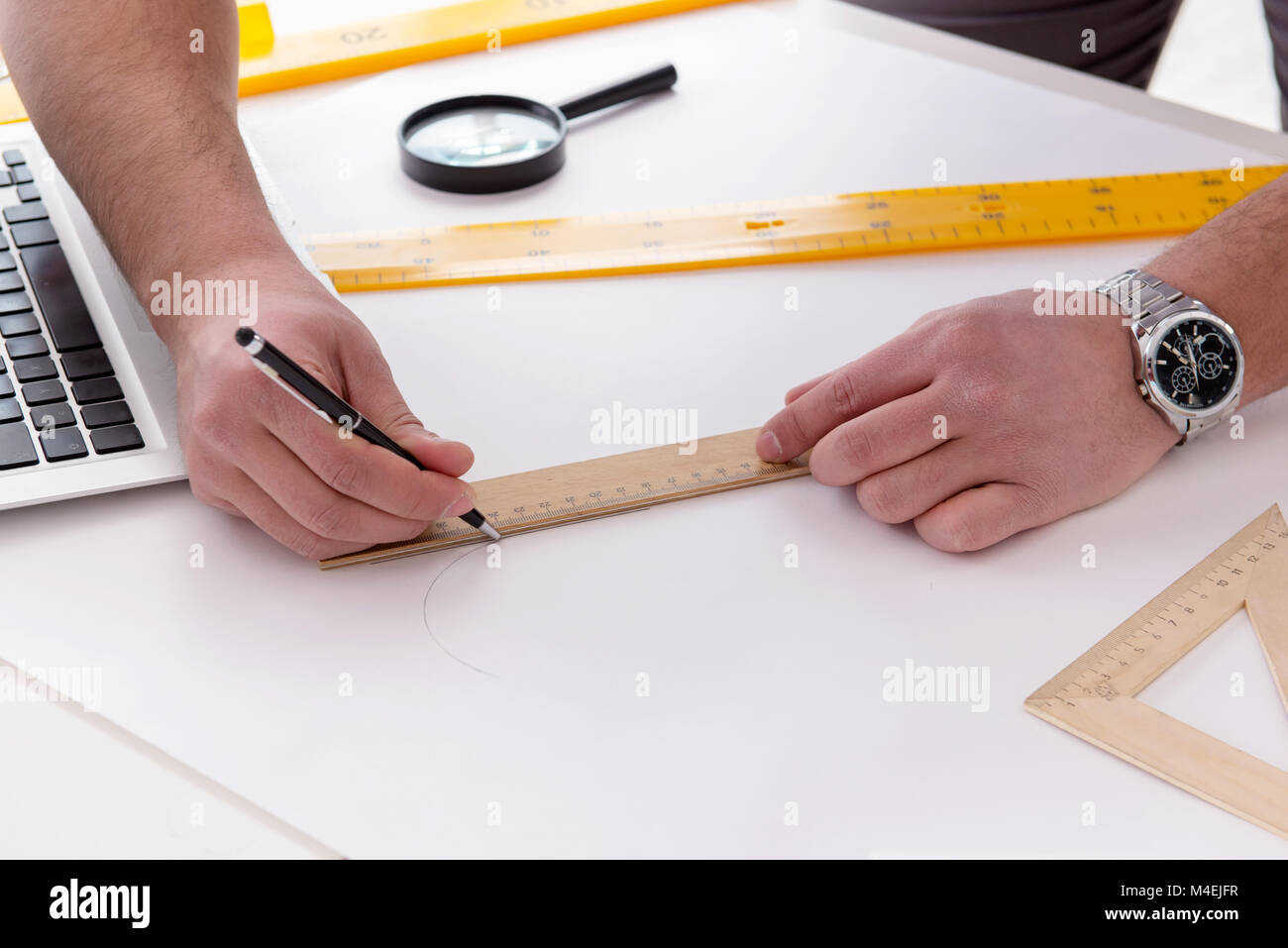 Male engineer working on drawings and blueprints Stock Photo Alamy