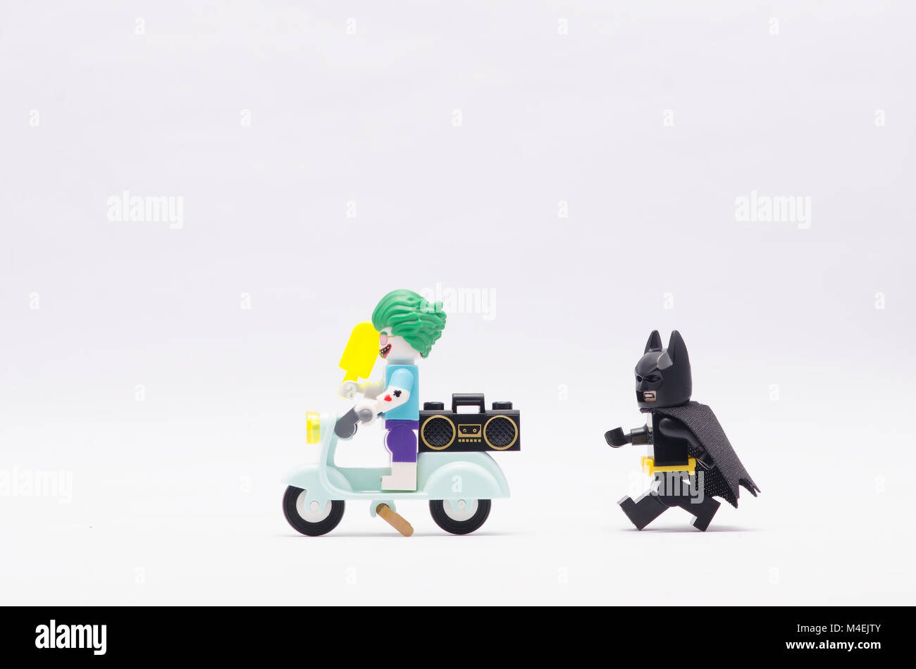 lego batman chasing joker riding a scooter. isolated on white background  Stock Photo - Alamy