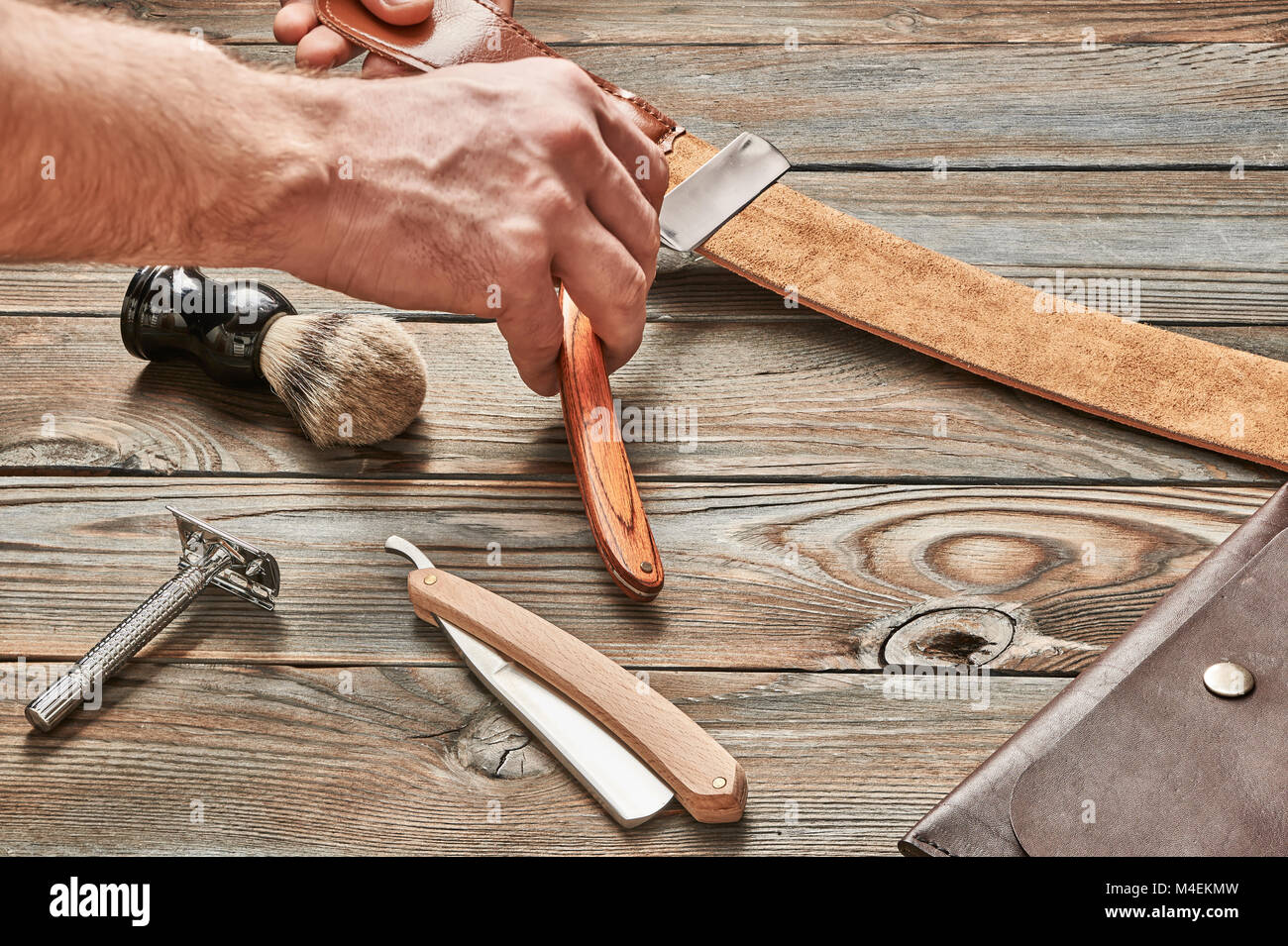Man stropping straight razor with leather tool Stock Photo Alamy