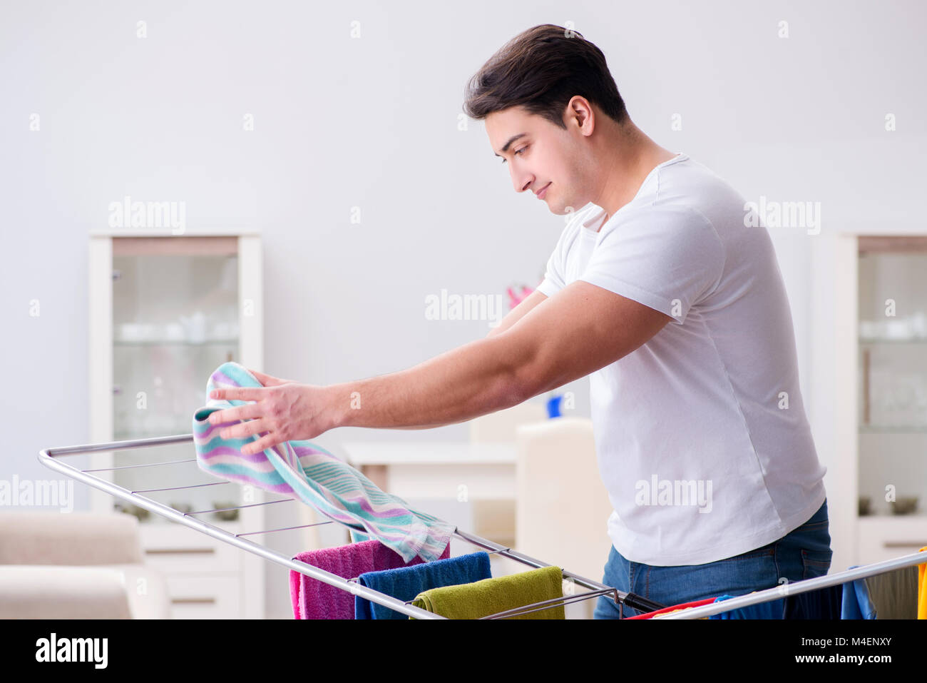 Man doing laundry at home Stock Photo - Alamy