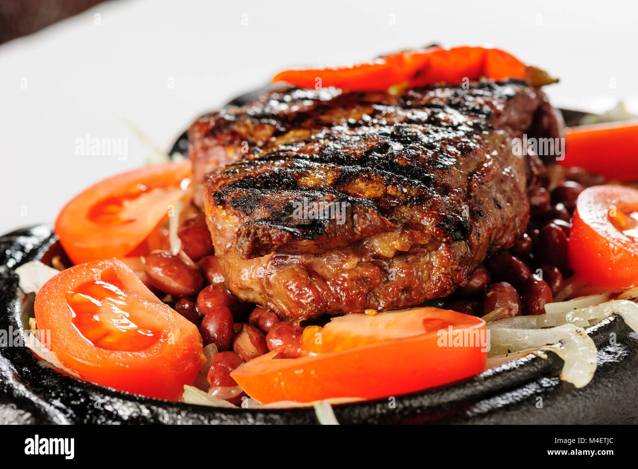Beef steak with red beans garnish Stock Photo