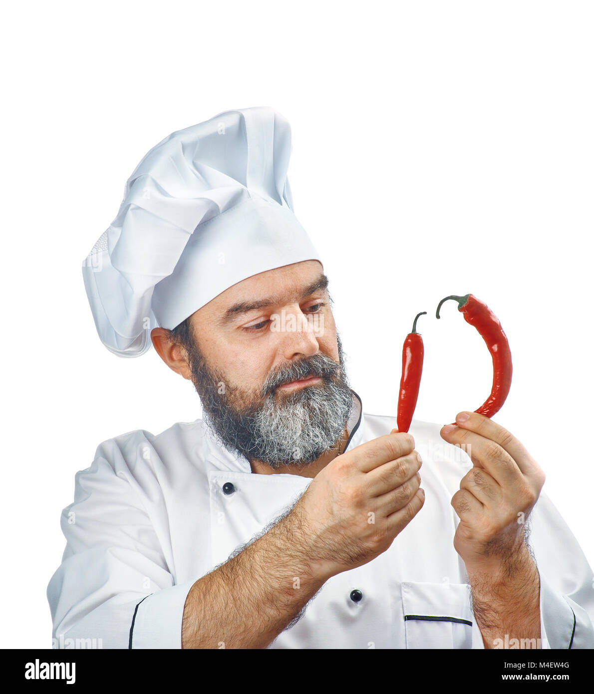 chief cook holding Two chili peppers Stock Photo