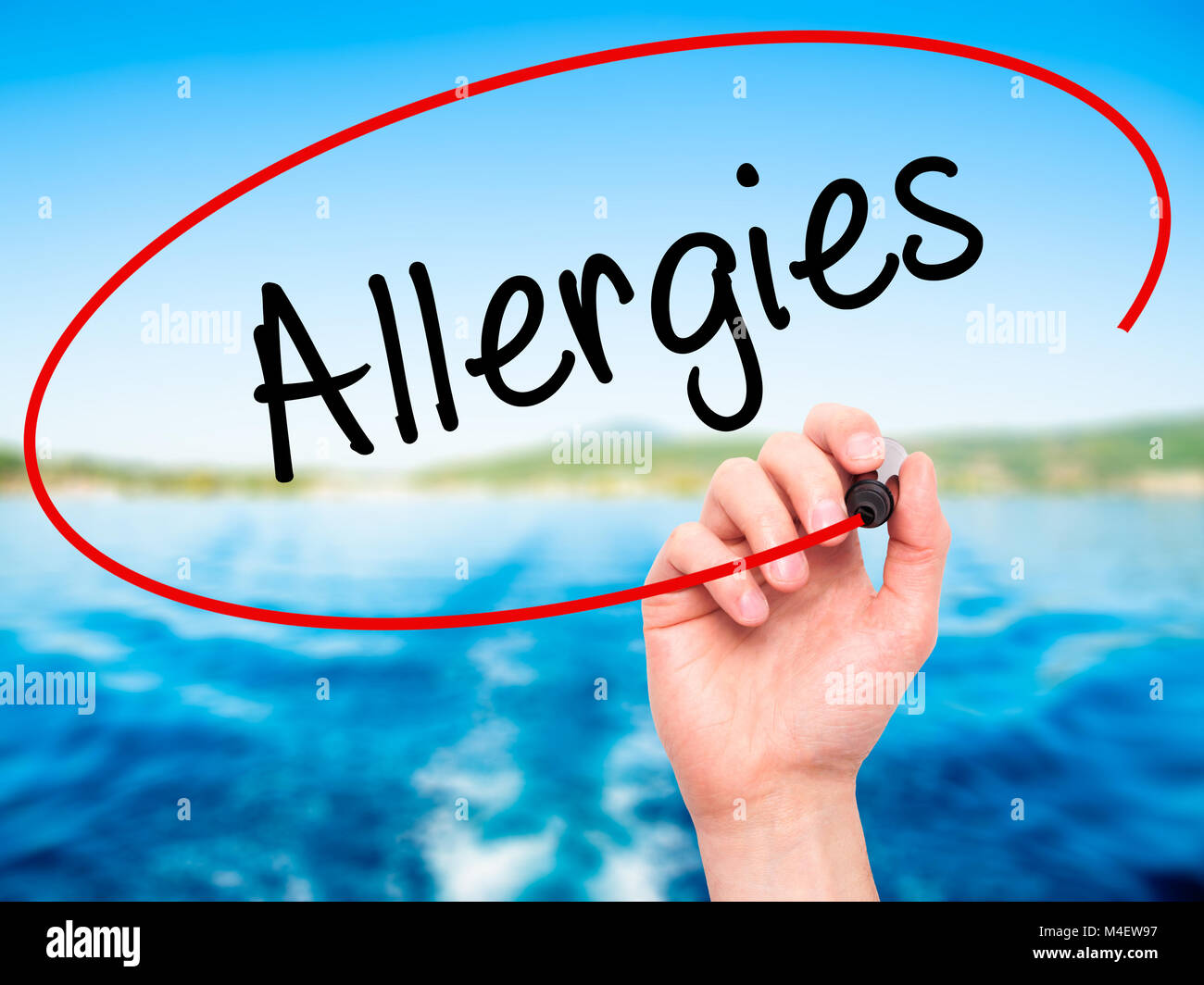 Man Hand writing Allergies with black marker on visual screen Stock Photo