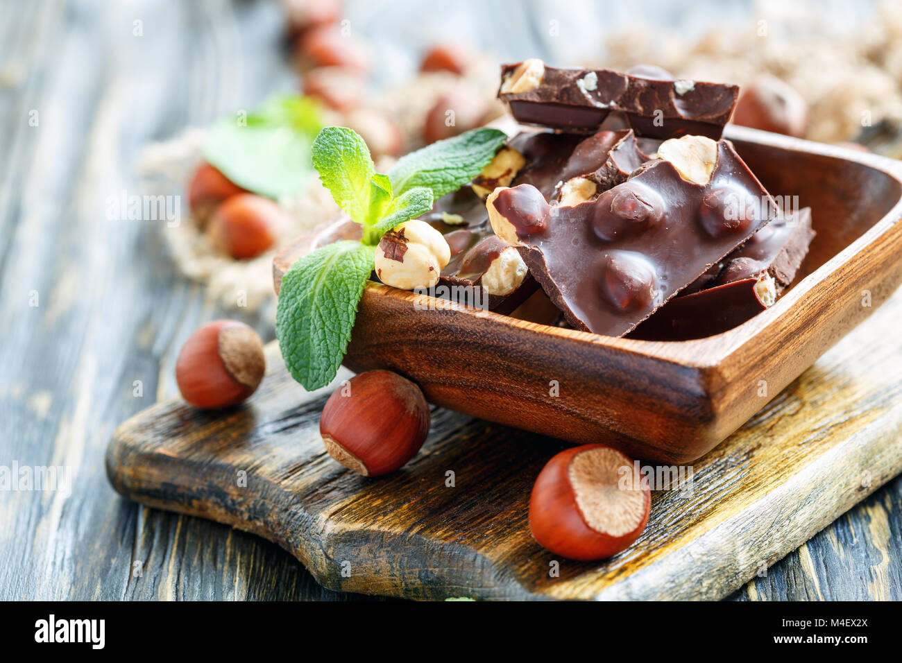 Dark chocolate with hazelnuts and mint leaves. Stock Photo