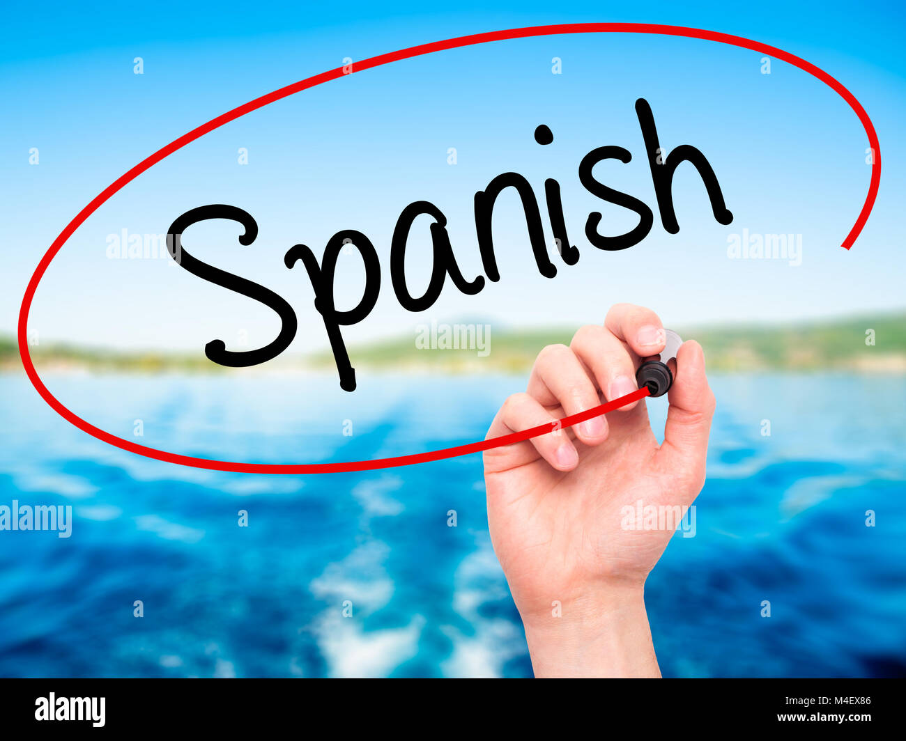 Man Hand writing Spanish with black marker on visual screen Stock Photo