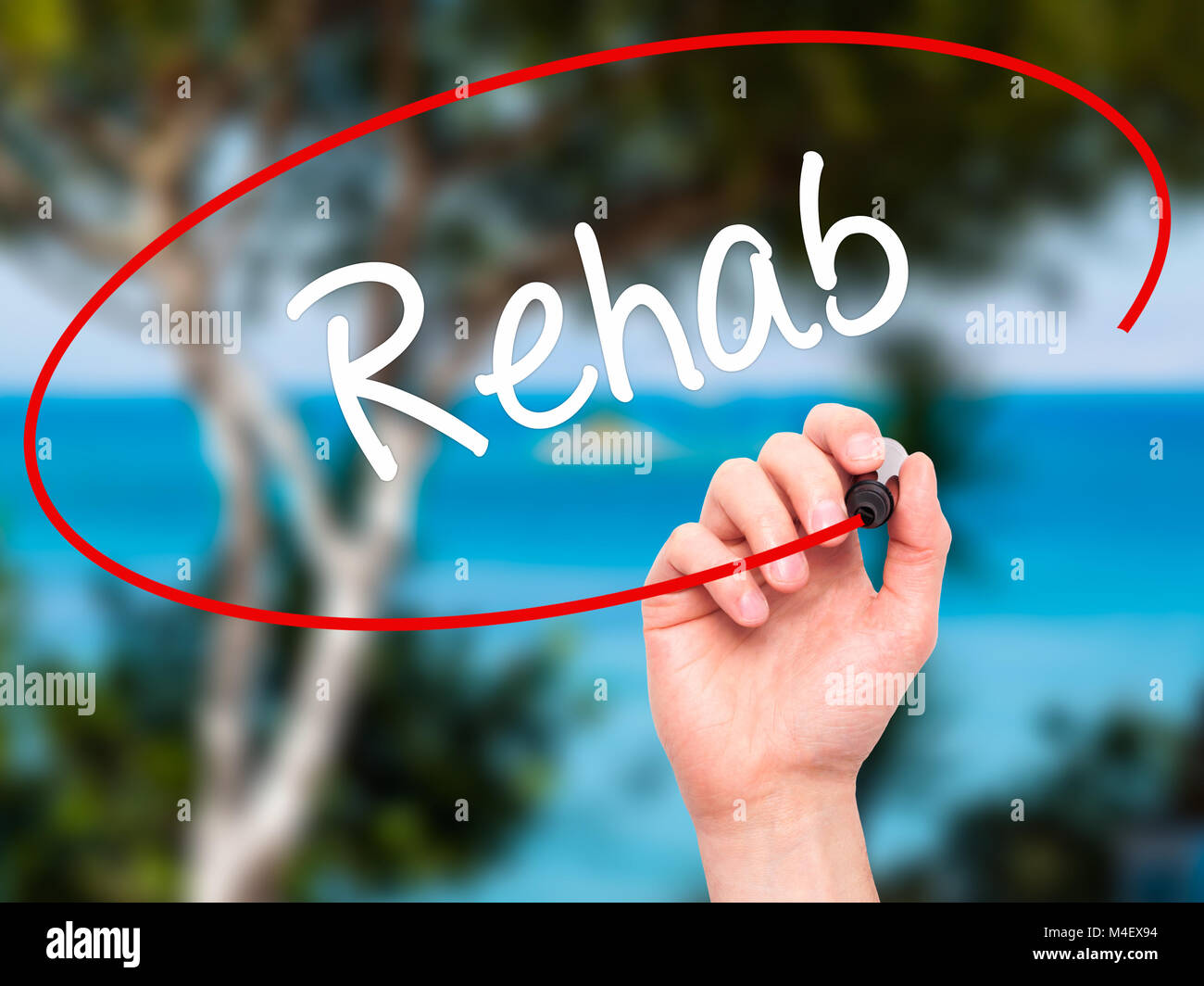 Man Hand writing Rehab with black marker on visual screen Stock Photo