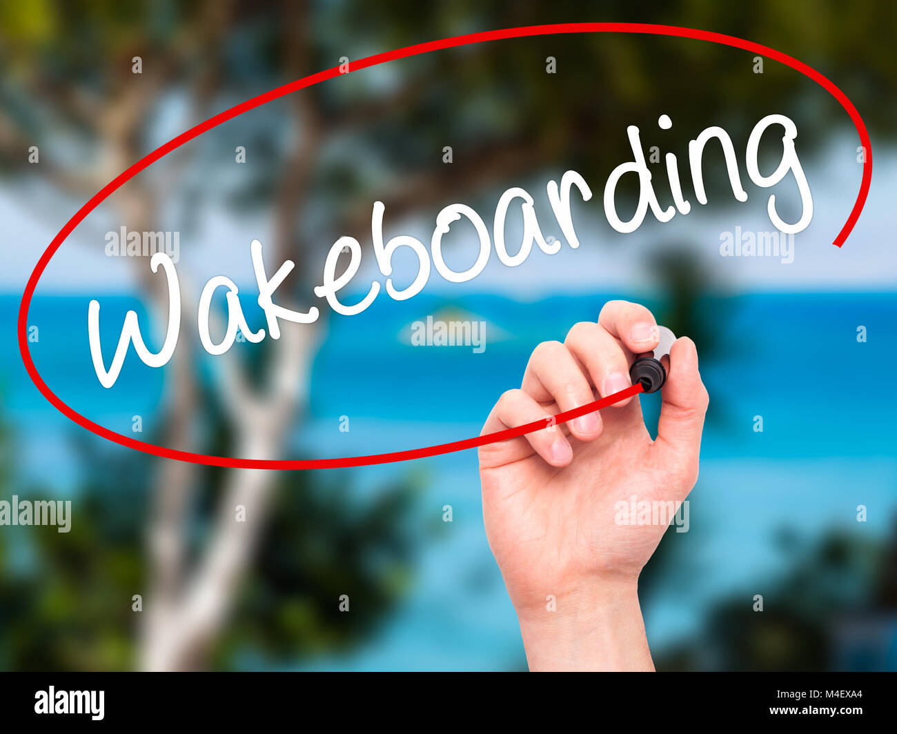 Man Hand writing Wakeboarding with black marker on visual screen. Stock Photo