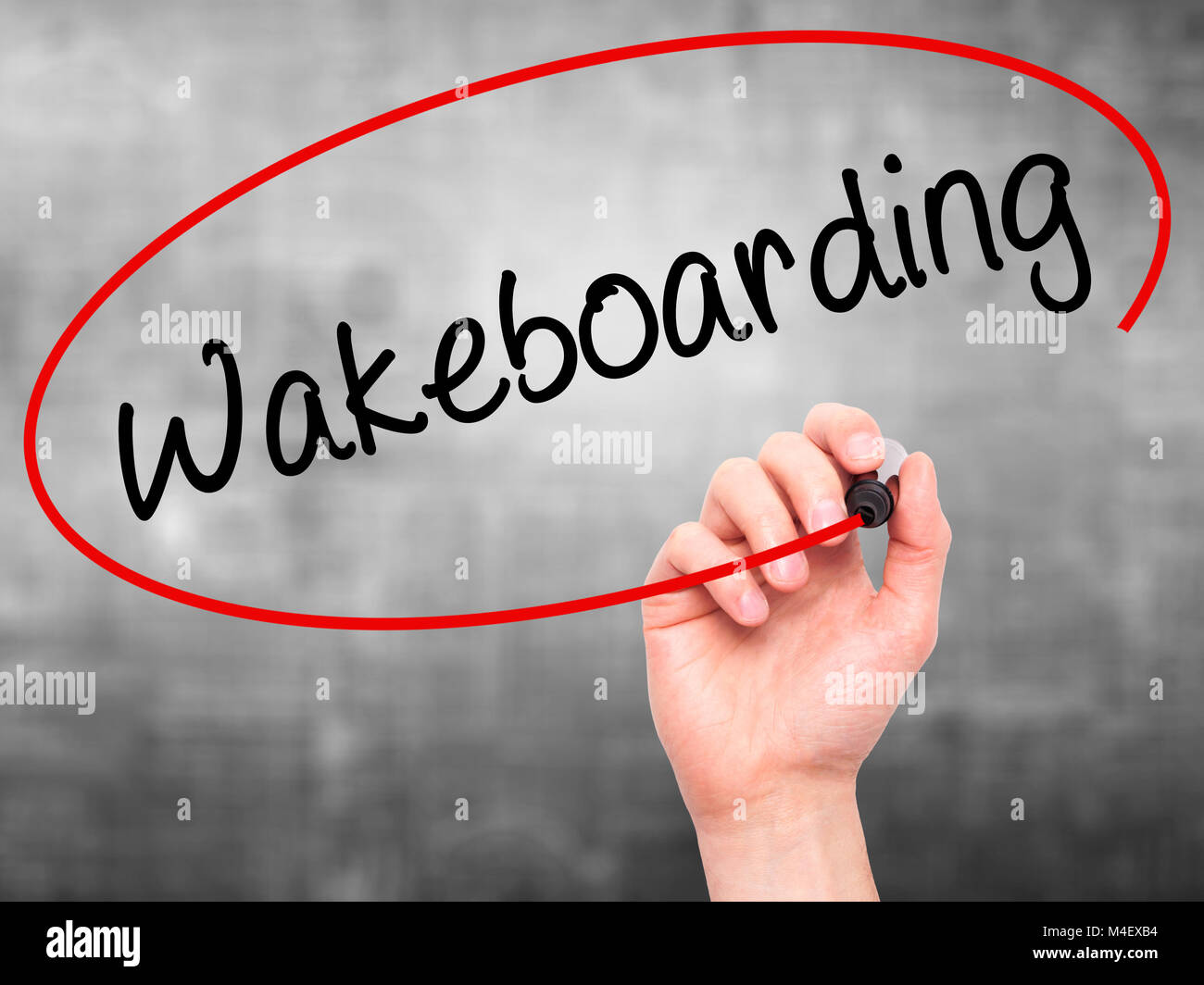 Man Hand writing Wakeboarding with black marker on visual screen. Stock Photo