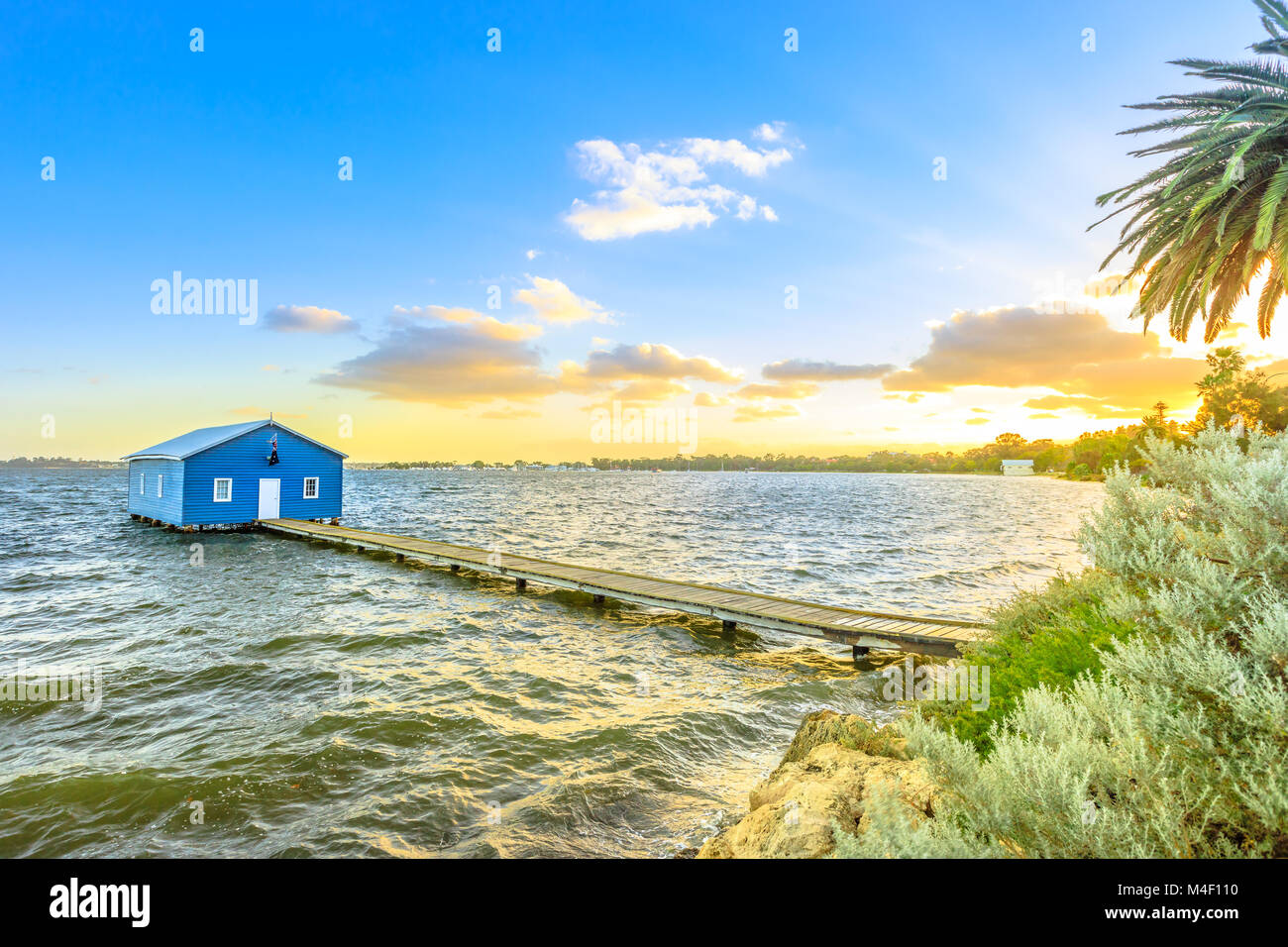 Blue Boat House: the iconic and most photographed Perth landmark in Western Australia. Scenic sunset landscape on the Swan River. Boathause with wooden jetty and copy space. Stock Photo