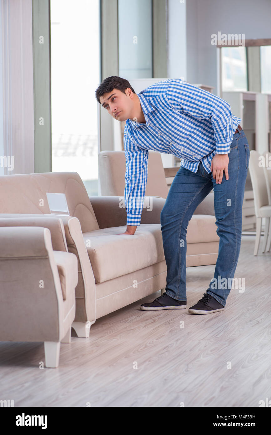 Young man shopping in furniture store Stock Photo - Alamy