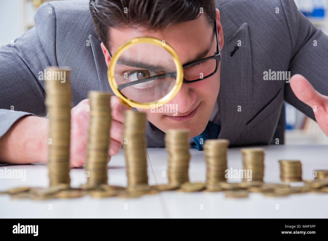 Businessman with golden coins in business growth concept Stock Photo ...