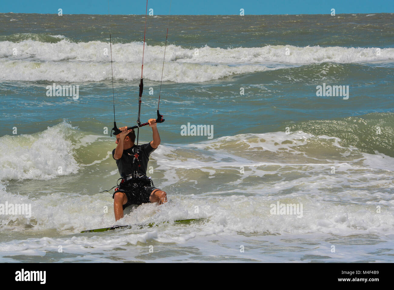 A Kite Boarder navigating the surf Stock Photo