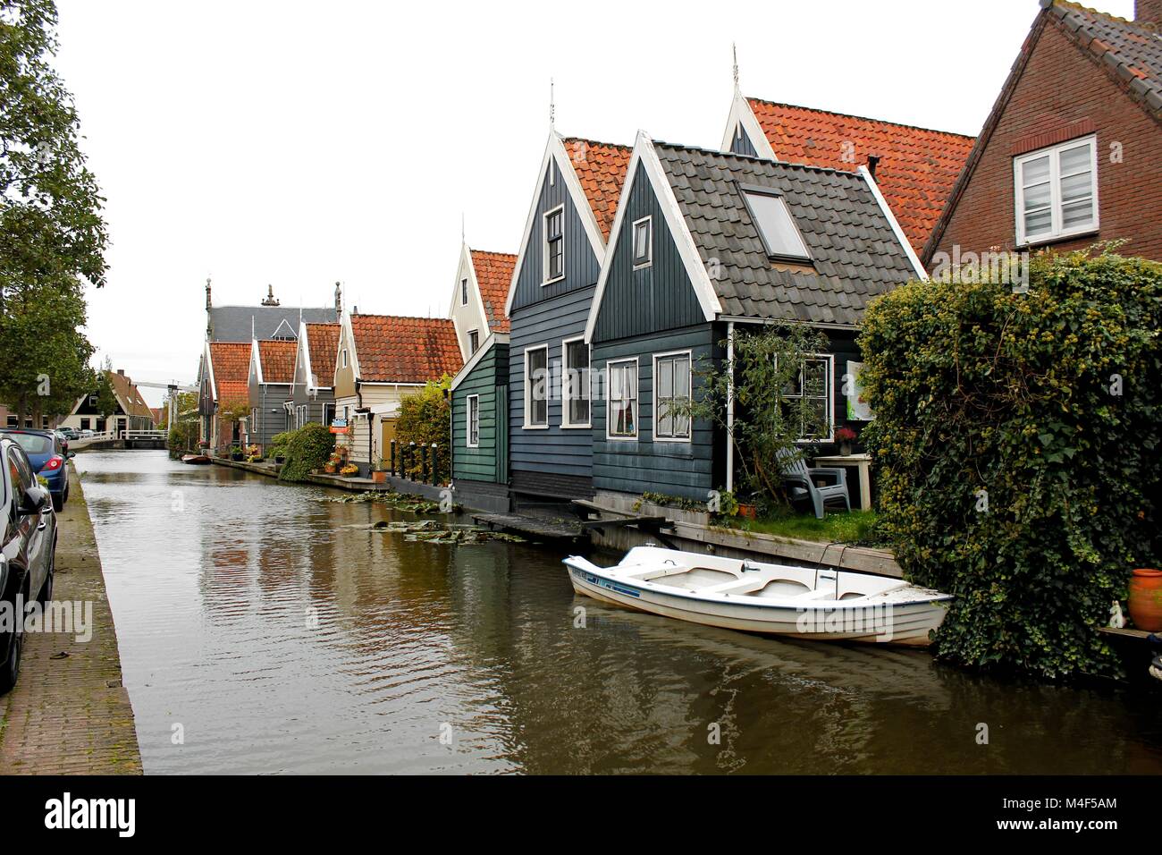 Traditional blue Dutch row canal houses with reflection on water