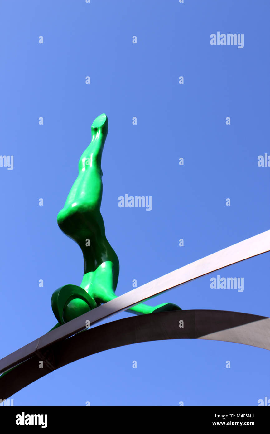 Upright view of green Spofforth sculpted figure against deep blue sky Stock Photo