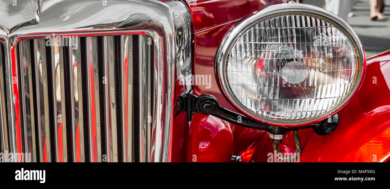 The headlight and grill of a classic European car. Stock Photo