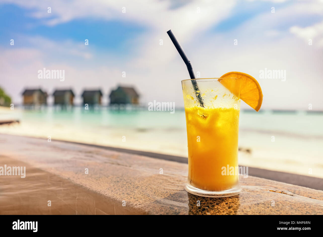 Fresh orange juice by the poolside. Tropical island in Maldives Stock Photo