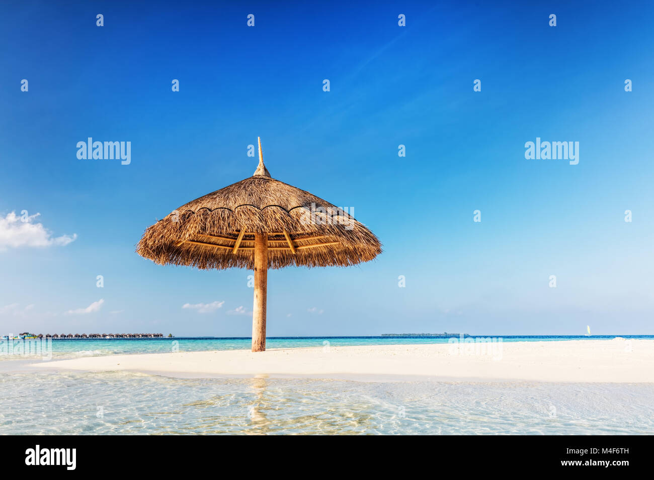 Tropical sandbank island with sunshade umbrella. Indian Ocean, Maldives. Stock Photo