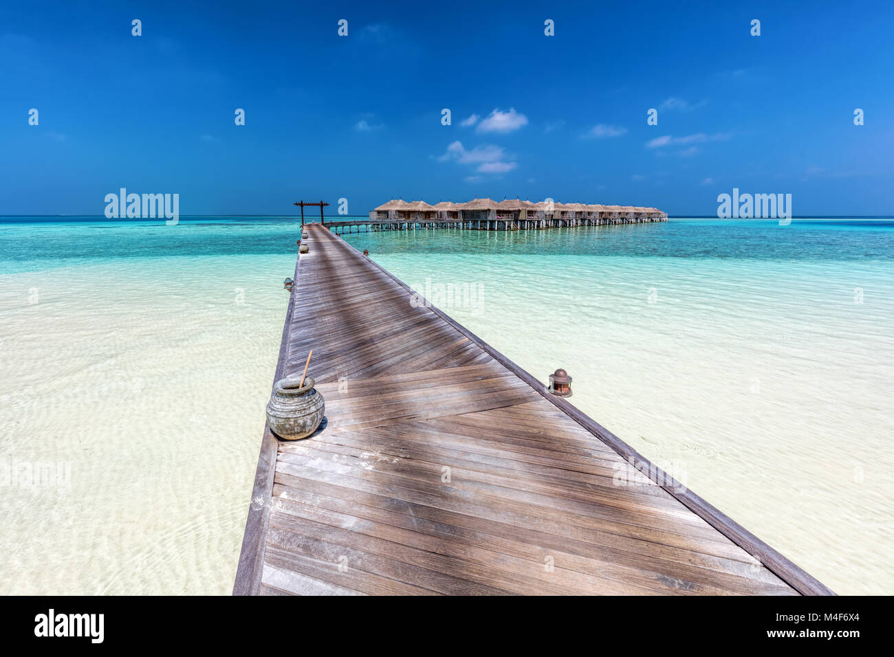 Wooden jetty towards water villas in Maldives. Stock Photo