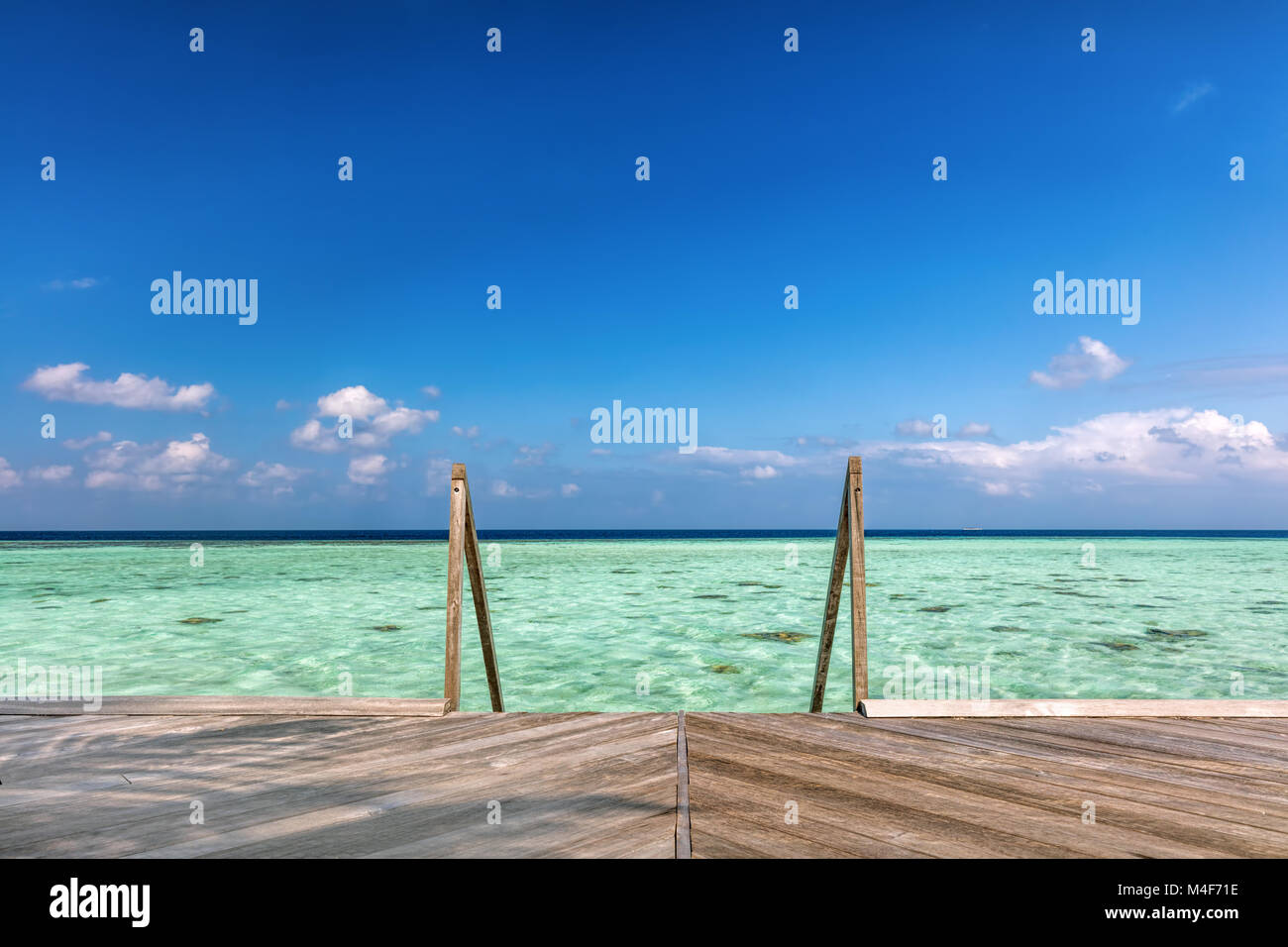 Wooden jetty towards water villas in Maldives. Stock Photo