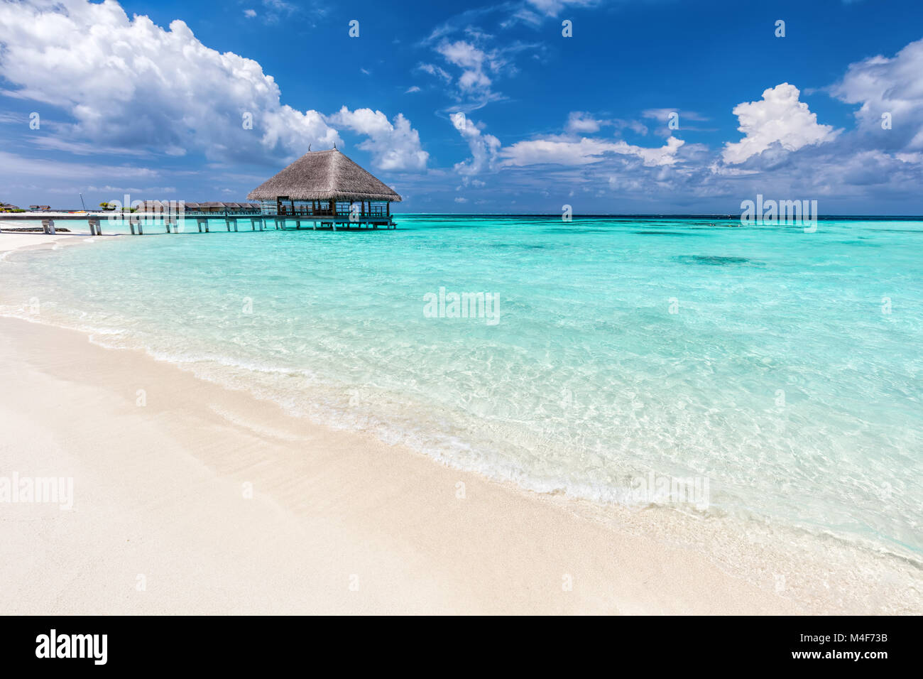 Maldives islands. Wooden jetty with water relaxation lodge. Stock Photo