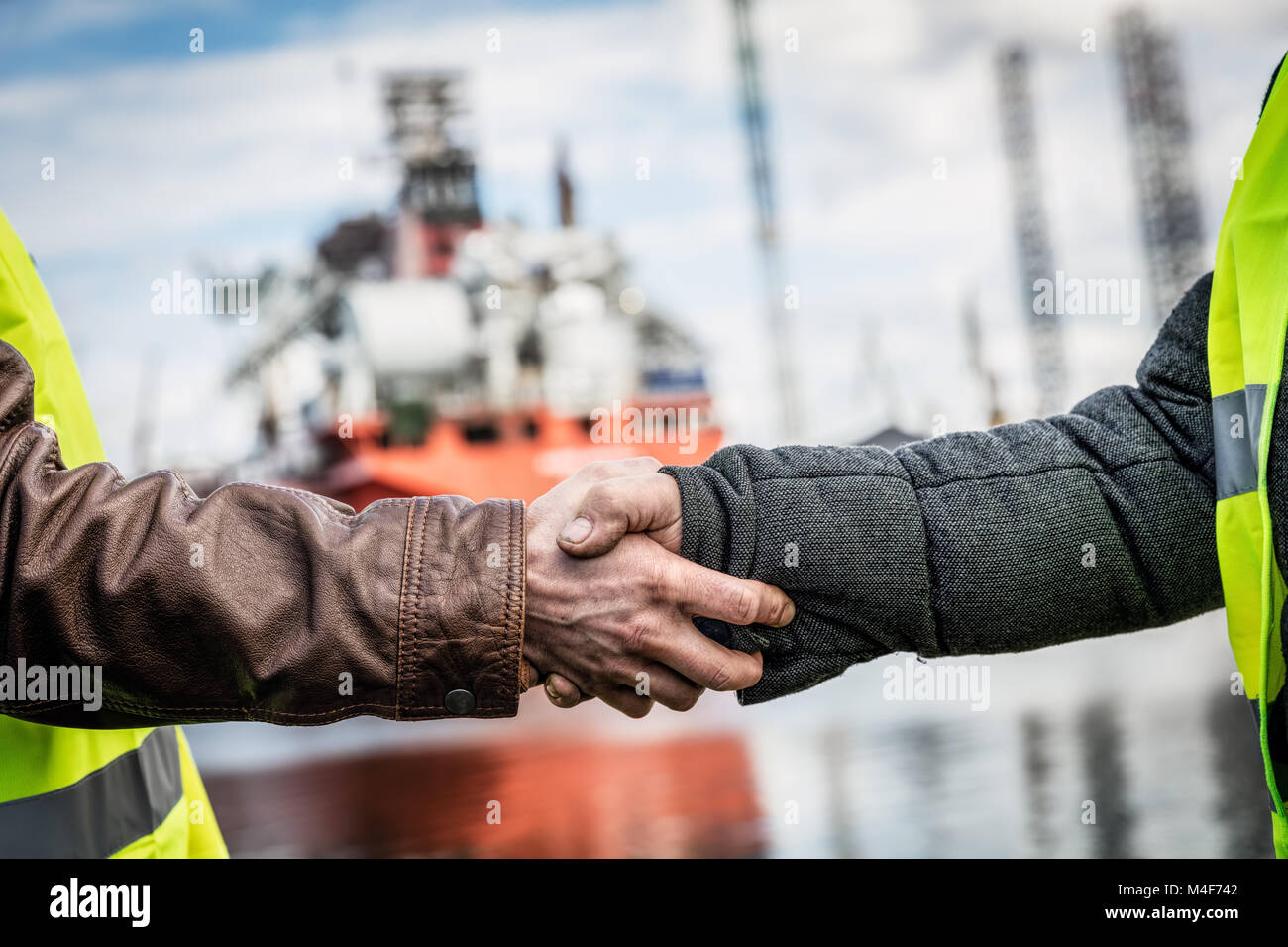 Business handshake in a shipyard. Shipbuilding industry Stock Photo