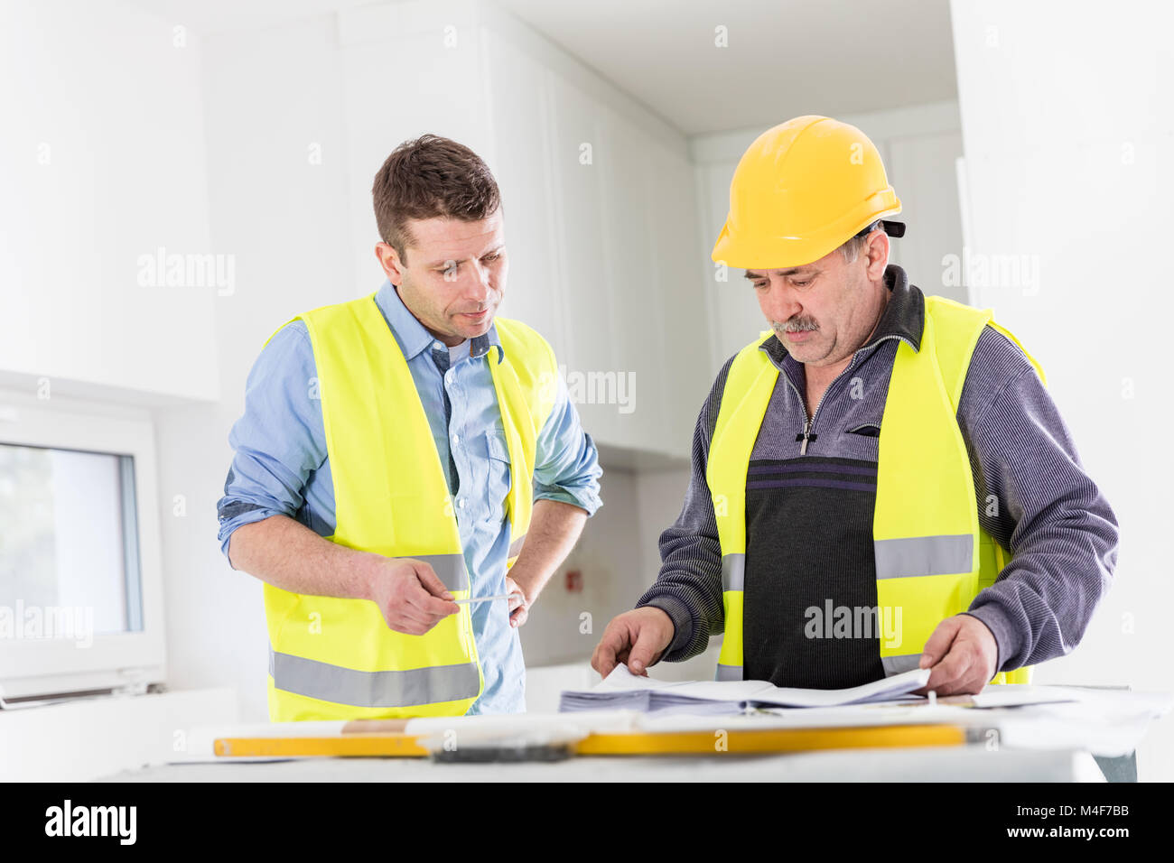 Architect and construction engineer indoor meeting. Stock Photo