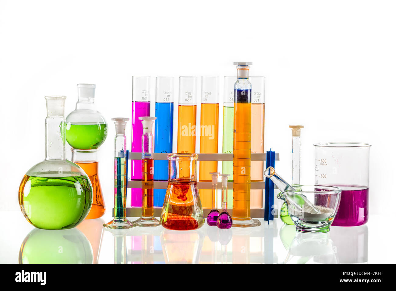 Laboratory glass set filled with colorful substances. Stock Photo