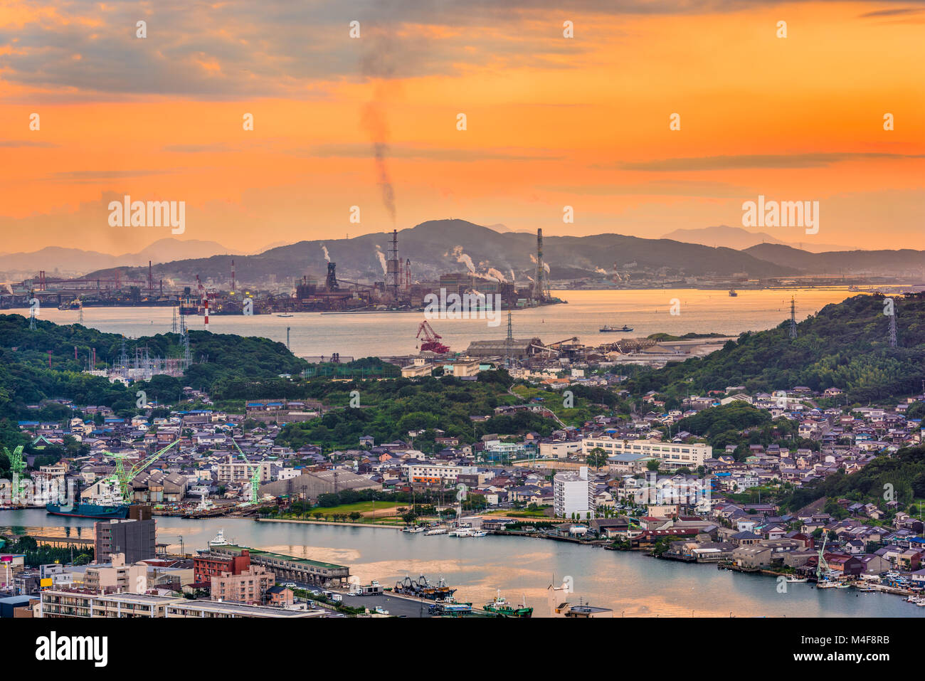 Shimonoseki, Yamaguchi, Japan skyline over the straits with industrial areas. Stock Photo