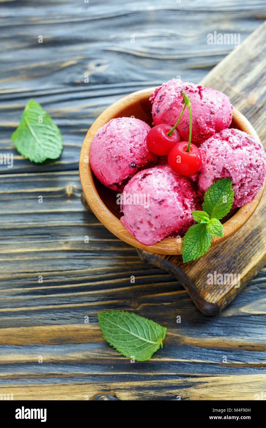 Berry ice cream with cherries in a wooden bowl Stock Photo - Alamy