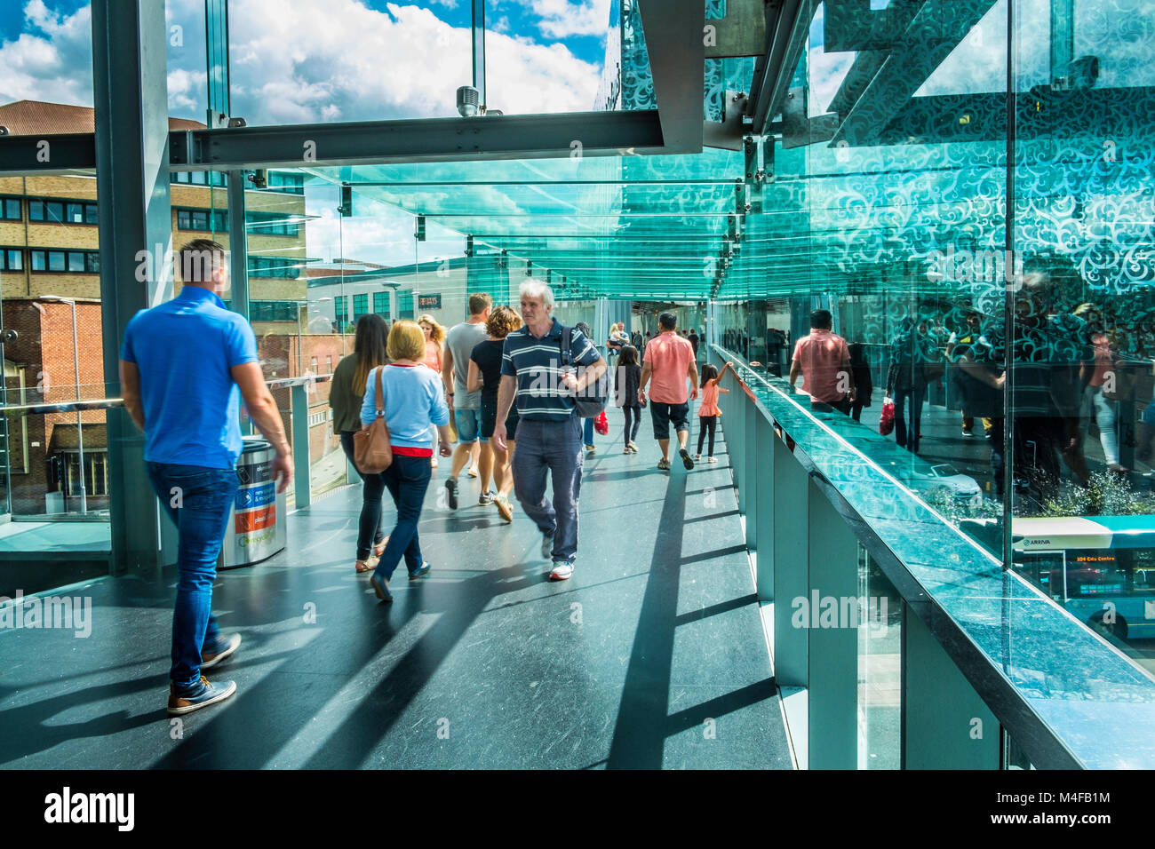 Glass walled pedestrian walkway at a shopping centre. Stock Photo