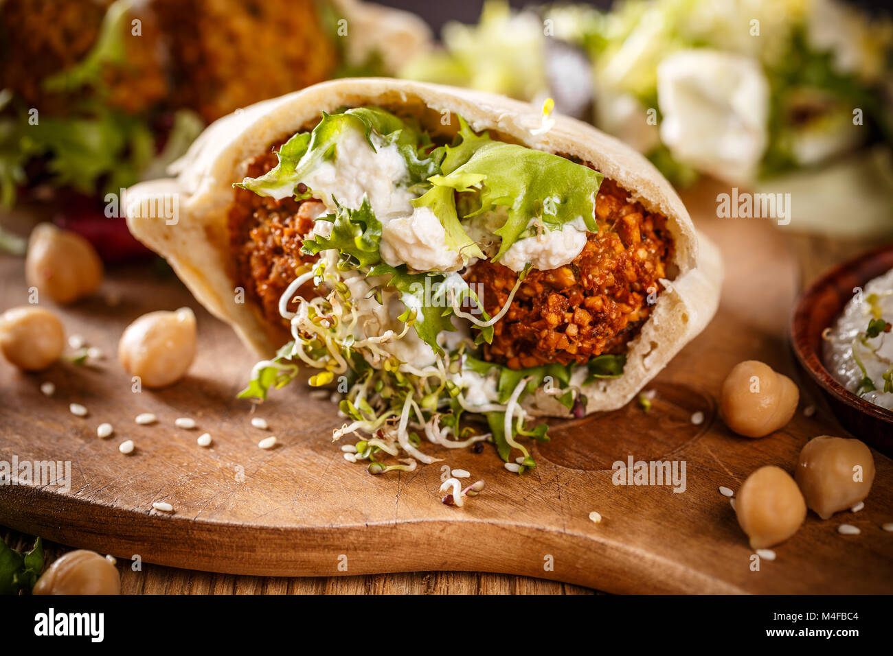 Delicious falafel snack ready to eat on wooden cutting board Stock Photo