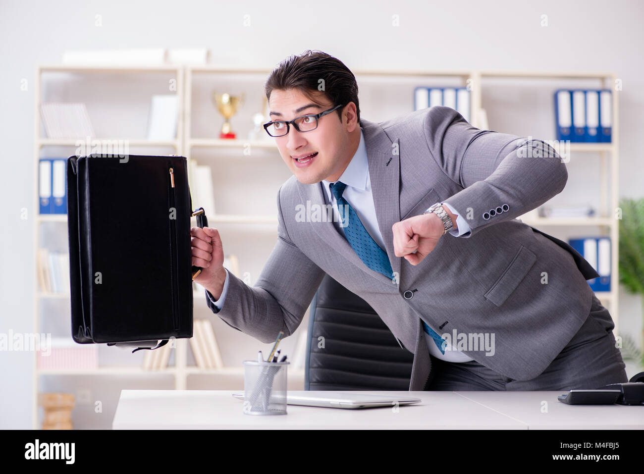 Businessman rushing in the office Stock Photo - Alamy
