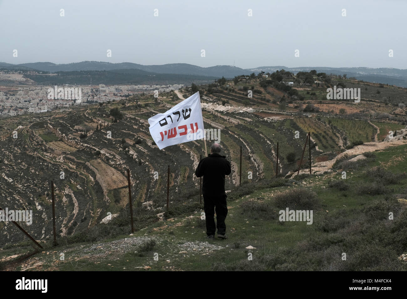 Member of the left-wing Peace Now movement taking part in a protest next to the illegal outpost of Nativ Ha'avot on following Israeli government attempts to postpone the removal of some of the houses in the outpost despite the Supreme Court ruling after accepting the petition of a group of Palestinians who argued the homes had been partially built illegally on their land. Stock Photo