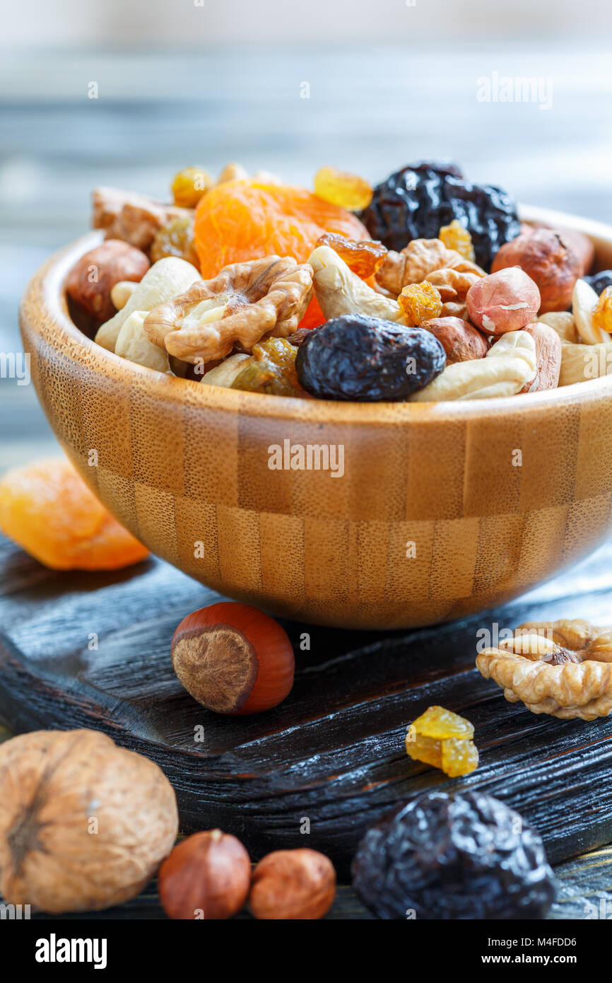 Nuts and dried fruit in a wooden bowl. Stock Photo