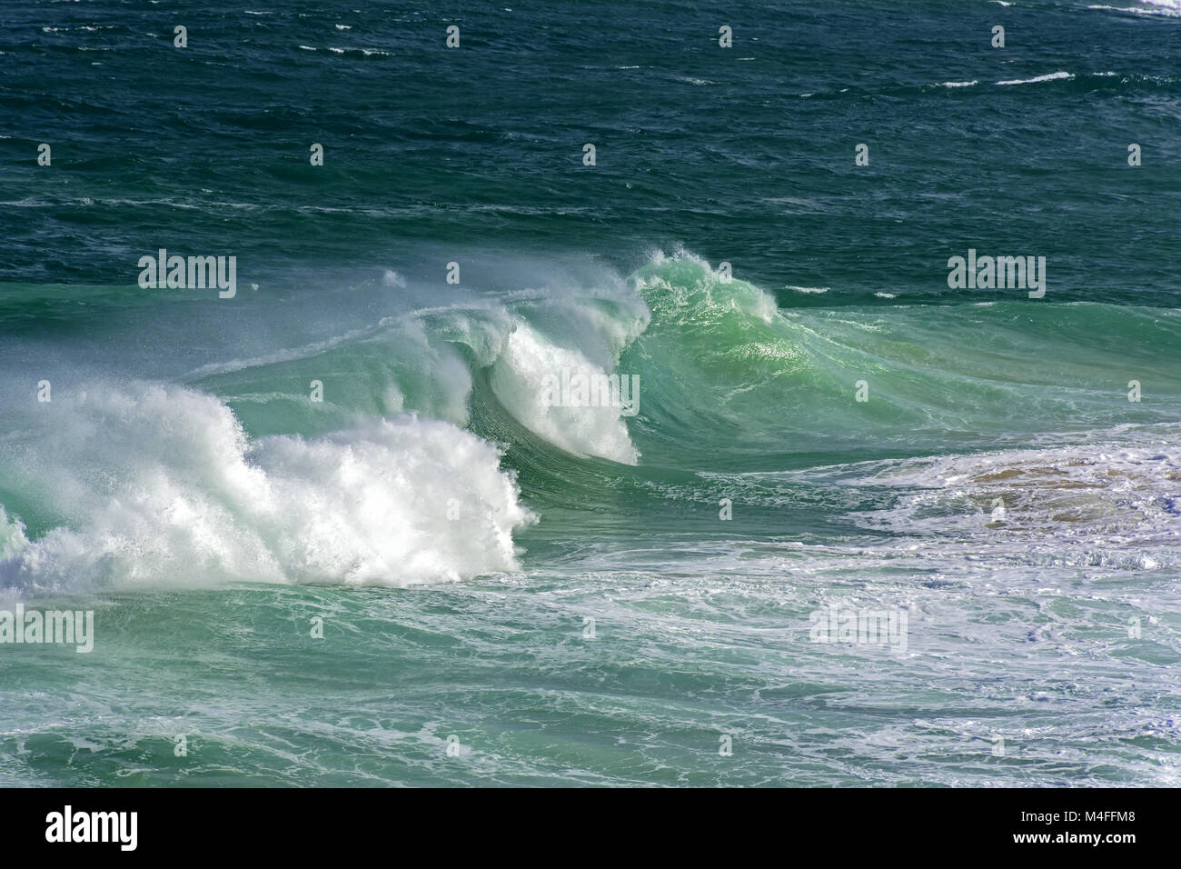 Wave crashing on beach Stock Photo - Alamy