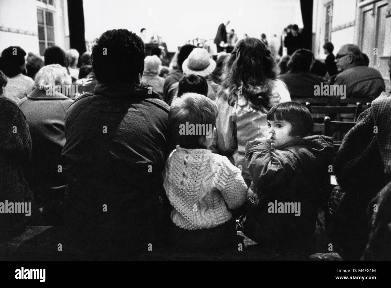 Audience watching performers on stage at small eisteddfod in village hall at Abergorlech Dyfed Wales UK Stock Photo