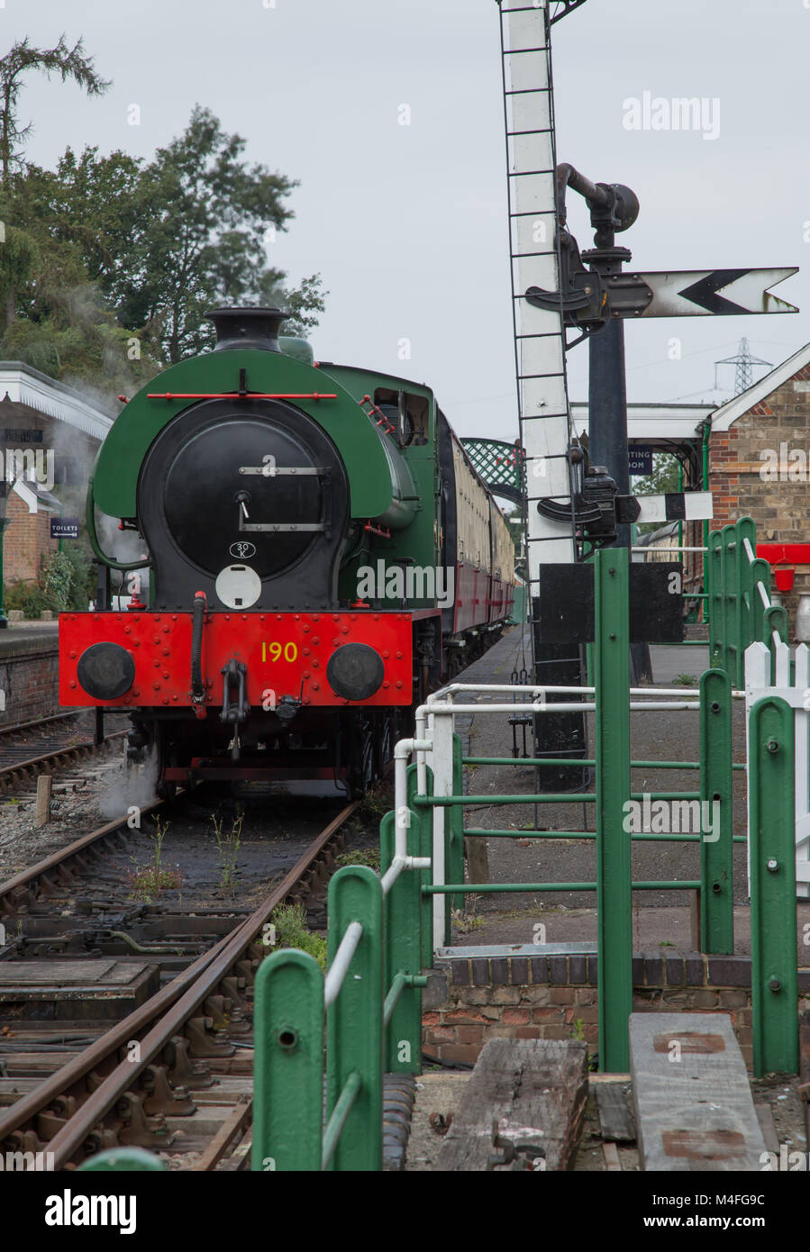 photo of a 0.6.0 locomotive pulling in to a station Stock Photo - Alamy