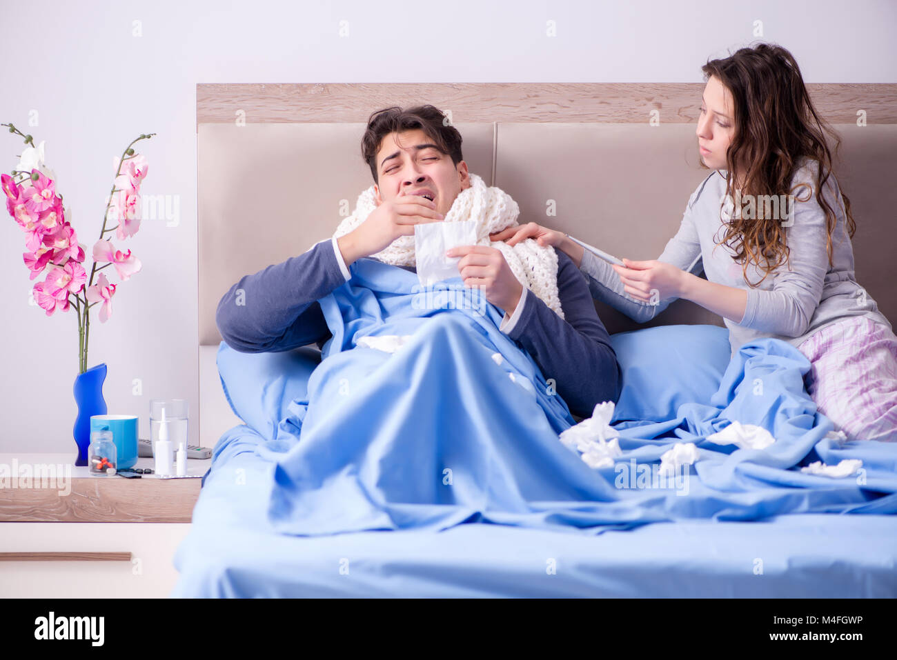 Wife caring for sick husband at home in bed Stock Photo - Alamy