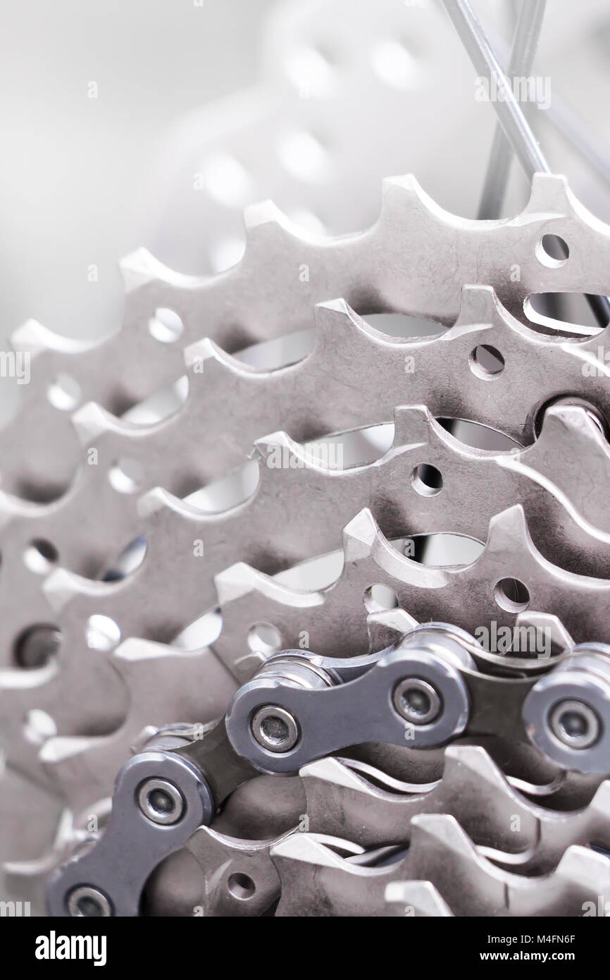 Mountain bike wheel and gear detail with a new clean chain and metal chain rings. Stock Photo