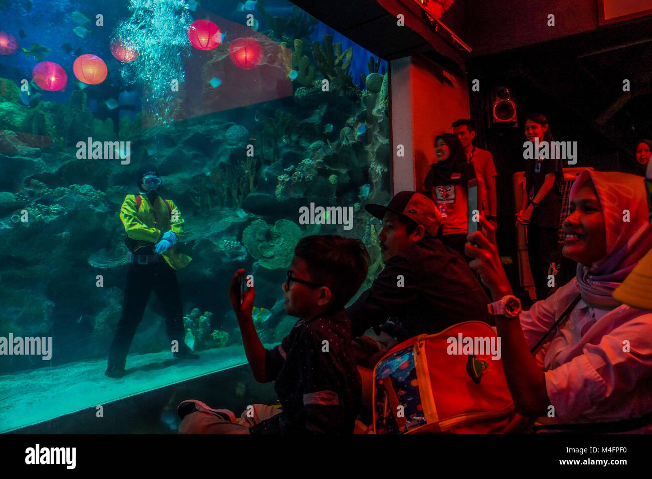 Kuala Lumpur, Malaysia. 16th Feb, 2018. People watch a Kung Fu performances by professional diver inside the Aquaria KLCC during Chinese New Year celebration in Kuala Lumpur on February 16, 2018. The Chinese Lunar New Year on February 16 will welcome the Year of the dog (also known as the Year of the Earth Dog). Credit: Samsul Said/AFLO/Alamy Live News Stock Photo