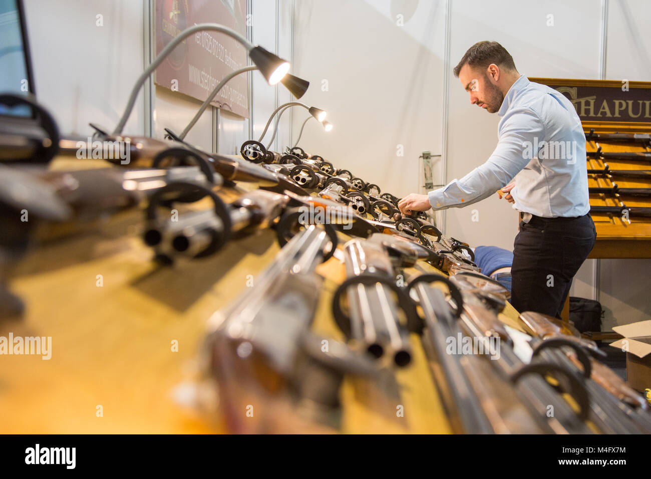 gunsmith preparing a display of shotguns at the great british shooting show nec 2018 Stock Photo