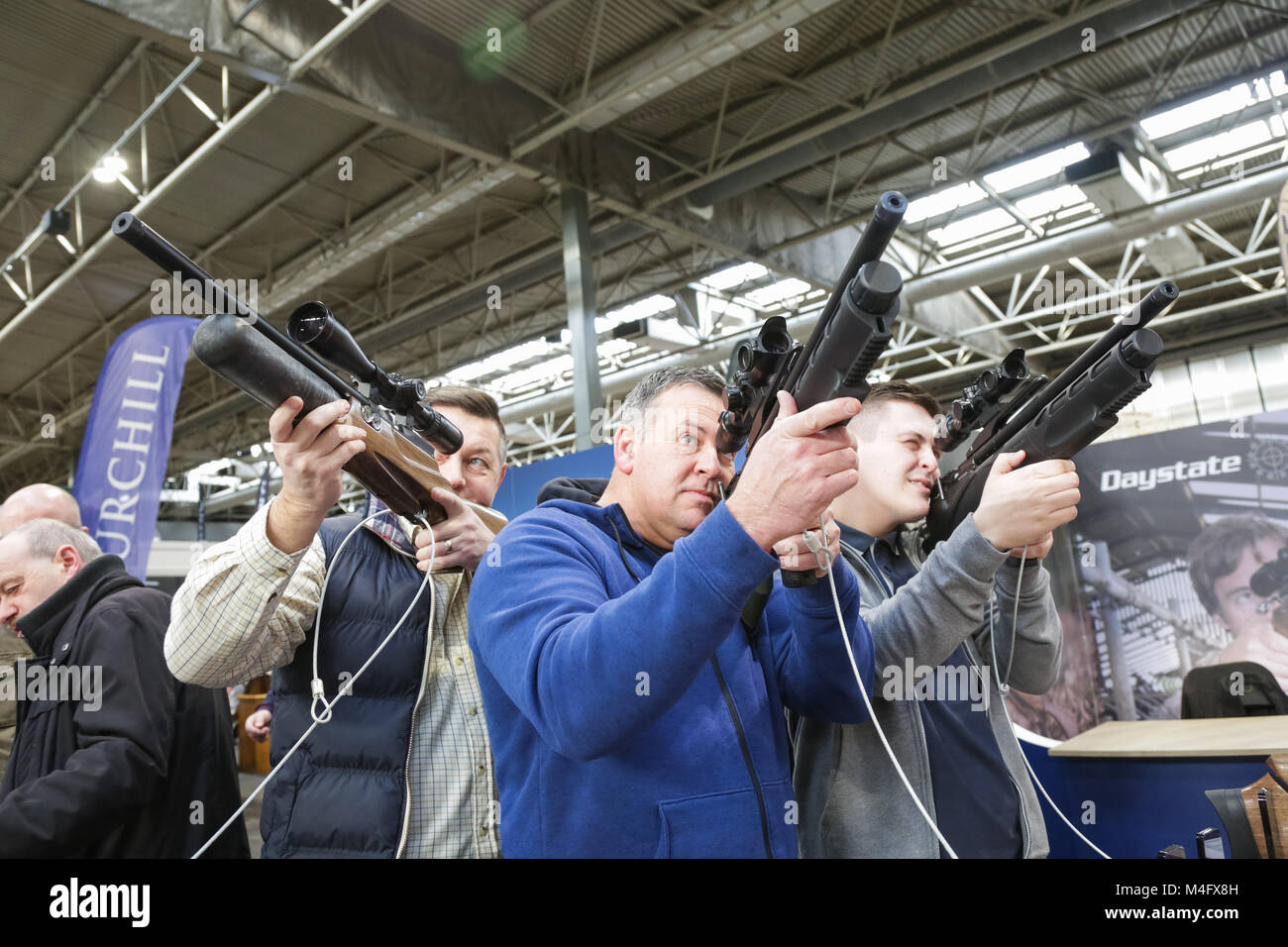 Men holding rifles or guns and sights at the Great British Shooting Show Stock Photo